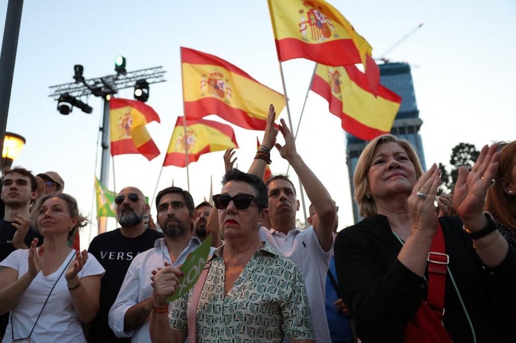 Apoiadores do partido de extrema-direita VOX agitam bandeiras espanholas enquanto participam do comício de encerramento da campanha em Madri em 21 de julho de 2023, antes das eleições gerais de 23 de julho. — Foto: Thomas COEX / AFP