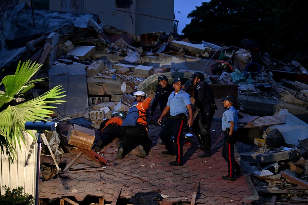 Equipes de resgate buscam vítimas em um prédio desabado após um terremoto em Caracas, em 24 de junho de 2026 — Foto: Juan Barreto/AFP