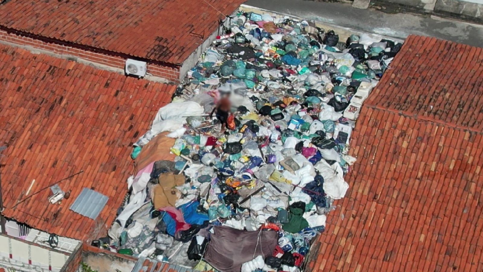 VÍDEO: Morador é flagrado caminhando sobre lixo acumulado no telhado de casa em Teresina