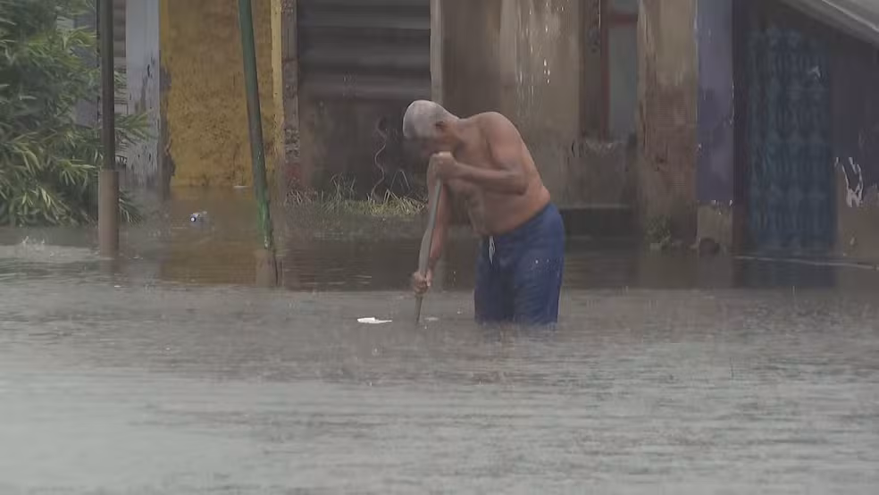 Morador desentupiu bocas-de-lobo de rua em Campo Grande, na Zona Oeste do Rio — Foto: Reprodução/ TV Globo