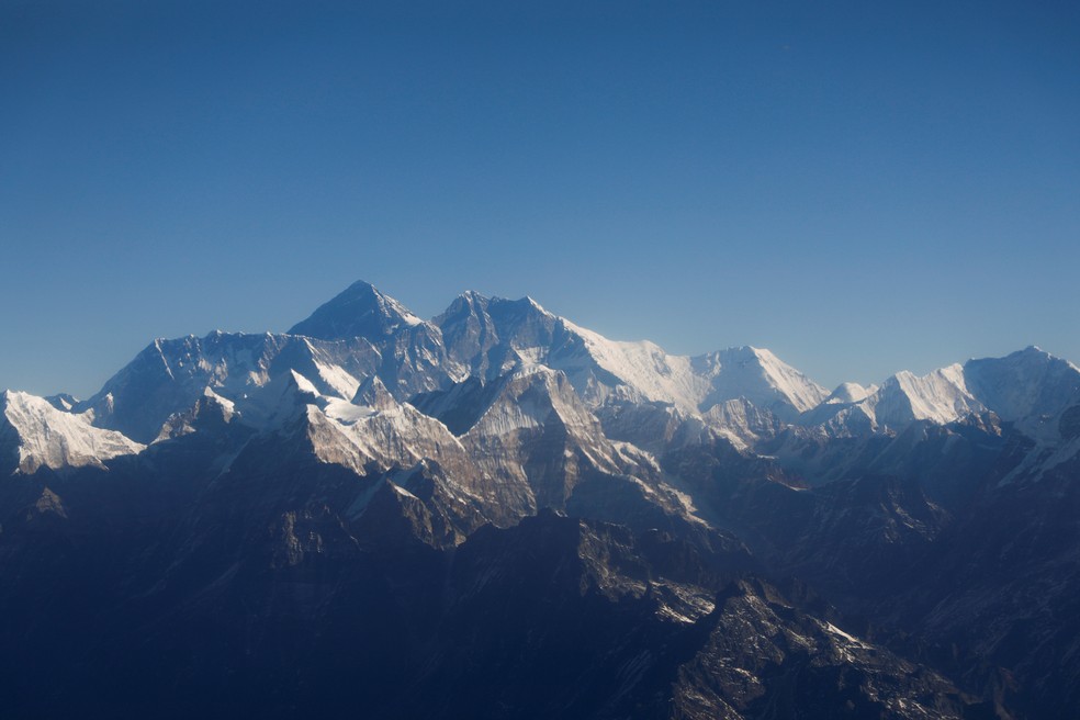 O Monte Everest, o pico mais alto do mundo, e outros picos da cordilheira do Himalaia são vistos através de uma janela de uma aeronave durante um voo de montanha em Katmandu, no Nepal, em janeiro de 2020 — Foto: Monika Deupala/Reuters/Arquivo