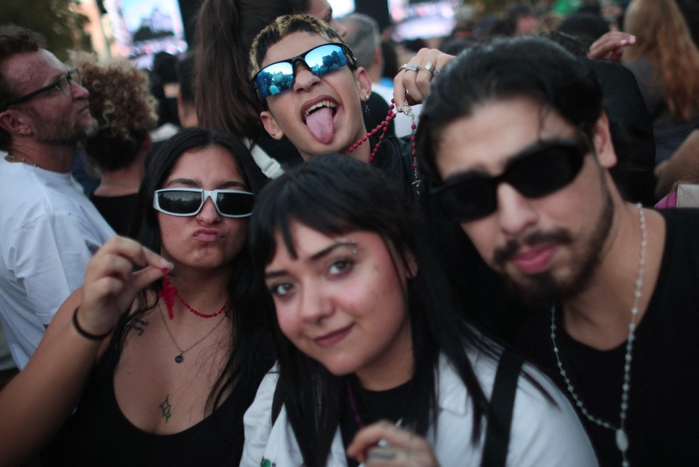 Jovens exibem terços durante apresentação do padre Peixoto em Buenos Aires — Foto: Tomas Cuesta/AFP