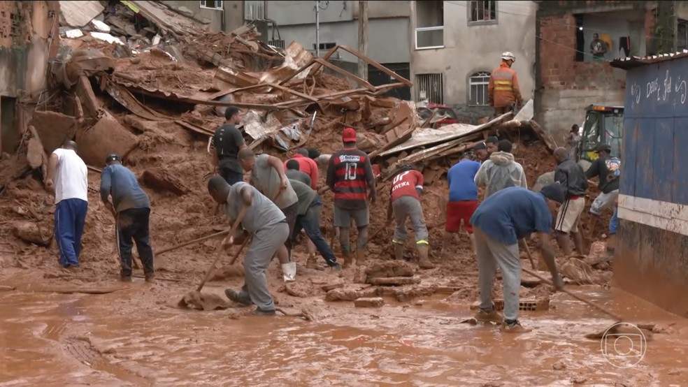 Moradores se juntam a bombeiros no resgate e no acolhimento de famílias na Zona da Mata (MG) — Foto: Jornal Nacional/ Reprodução