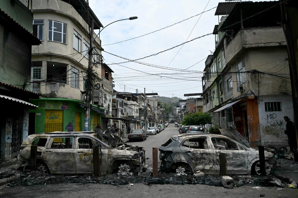 Criminosos fazem barricada com carros queimados — Foto: Mauro Pimentel/AFP