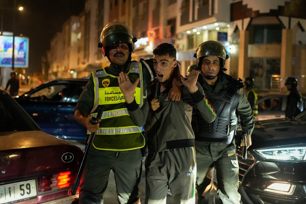 Jovem é detido por forças de segurança durante protestos da Geração Z em Salé, em Marrocos, em 1° de outubro de 2025. — Foto: AP Photo/Mosa'ab Elshamy