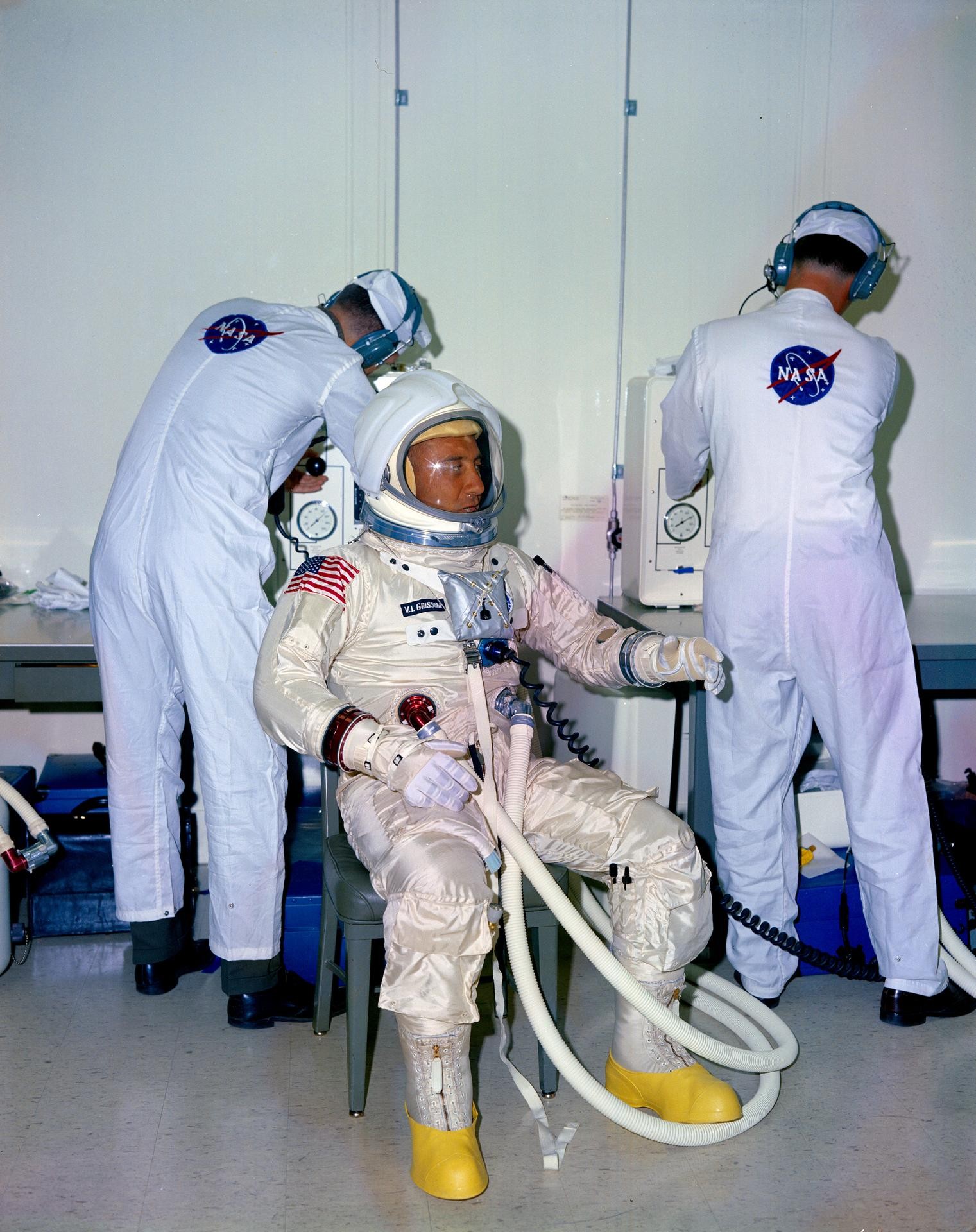 Técnicos de trajes da NASA auxiliam o astronauta Virgil I. Grissom durante o processo de vestir o traje antes de testes no Kennedy Space Center. — Foto: Reprodução/Nasa