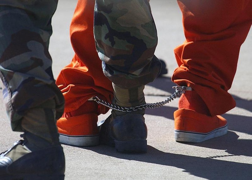 As medidas de segurança na chegada a Guantánamo eram extremas. Os detidos eram algemados nos pés e nas mãos e constantemente observados por mais de um soldado. — Foto: JEREMY T. LOCK/USAF via BBC