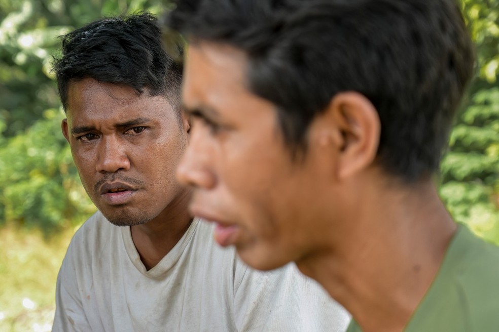 Umbu Ana Rara (à esquerda), um maramba (nobre), observando seu ata (escravo), Kanisius Kanyali Hambarita, na vila de Tanggedu, em Sumba — Foto: Bay Ismoyo/AFP