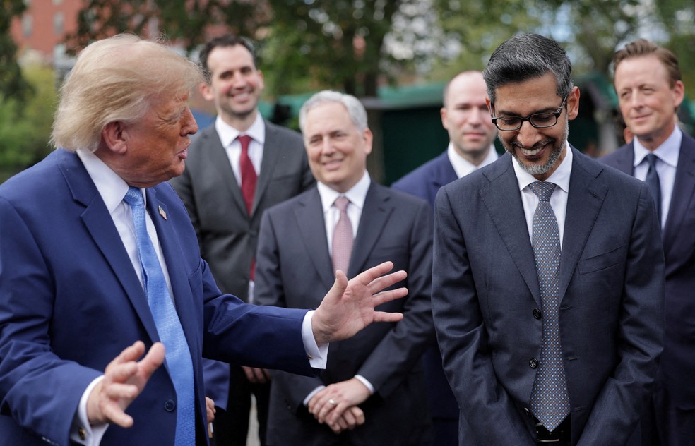 O CEO do Google, Sundar Pichai, ri enquanto o presidente dos EUA, Donald Trump, fala na entrada da Casa Branca — Foto: Jonathan Ernst / Reuters