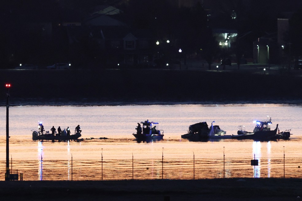 Equipes de resgate trabalham enquanto o sol nasce em Washington — Foto: Kevin Lamarque/Reuters