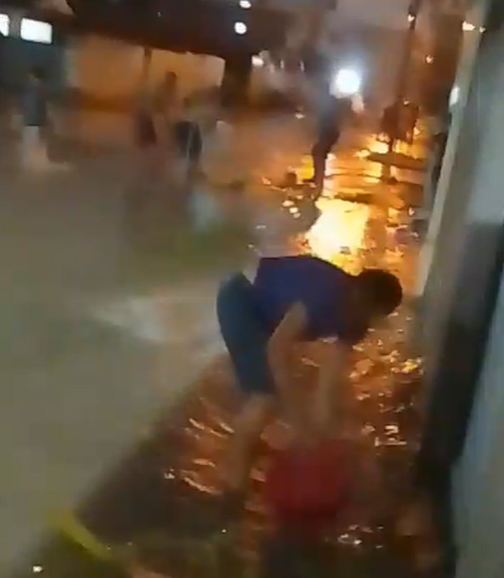 Moradores no bairro de Gramame tentam tirar excesso de água na entrada das casas — Foto: Redes Sociais
