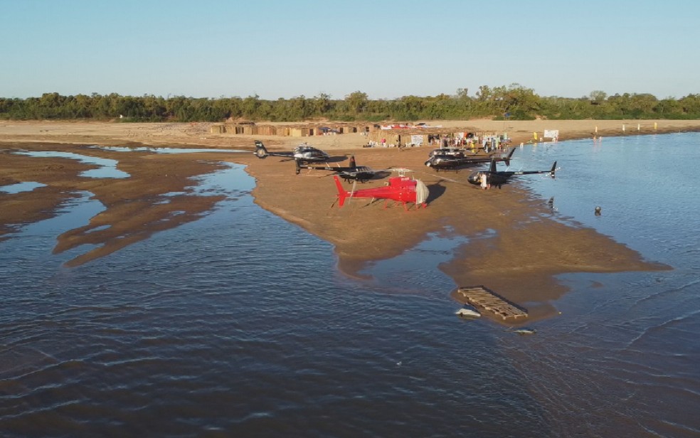Praia do Araguaia tem estacionamento de helicptero para chegar em acampamento de chals, em Aruan, Gois  Foto: Reproduo/TV Anhanguera