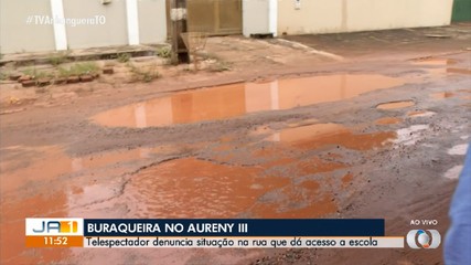 Buracos em rua que dá acesso a escola no Aureny III geram reclamações de moradores