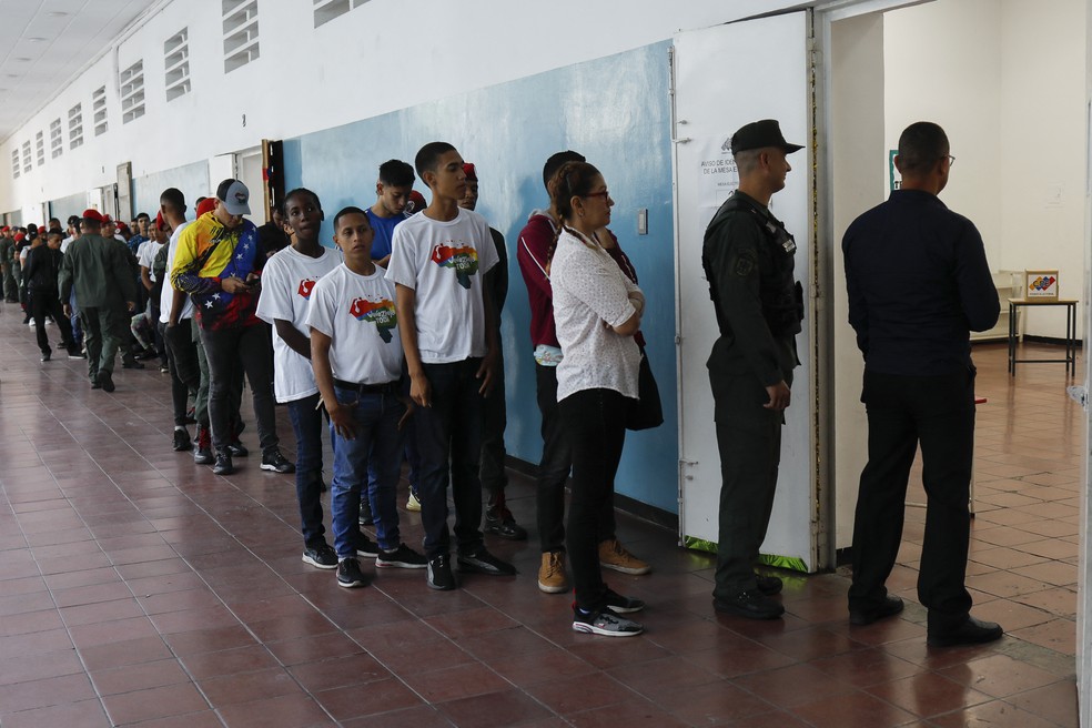 Membros das Foras Armadas da Venezuela organizam fila em ponto de votao em Caracas para o referendo sobre a anexao de territrio da Guiana — Foto: Pedro Rances Mattey/AFP