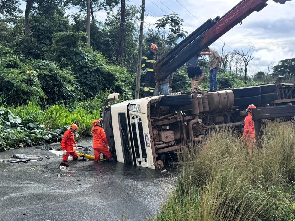 Com o tombamento, resíduos de soja se espalharam pelo acostamento. O material se misturou à água acumulada na pista, formando lama e dificultando o resgate. — Foto: Reprodução