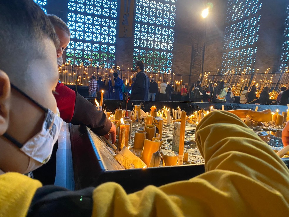 Imagem de arquivo - Criança acende vela na Basílica de Aparecida no Dia de Nossa Senhora de Aparecida — Foto: Poliana Casemiro/ g1