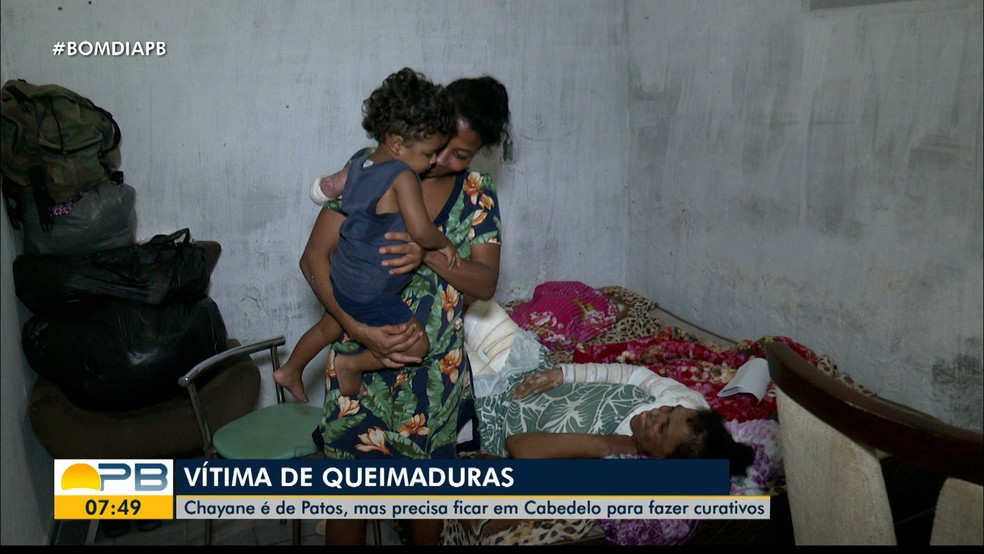 Ana Carolina com o filho nos braços e com Chayane deitada na cama de sua casa — Foto: TV Cabo Branco/Reprodução