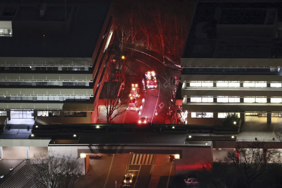 Equipes de emergência trabalhando no local onde ocorreu um ataque com martelo, no campus de Tama da Universidade de Hosei, em Machida, um subúrbio de Tóquio — Foto: Kyodo News via AP