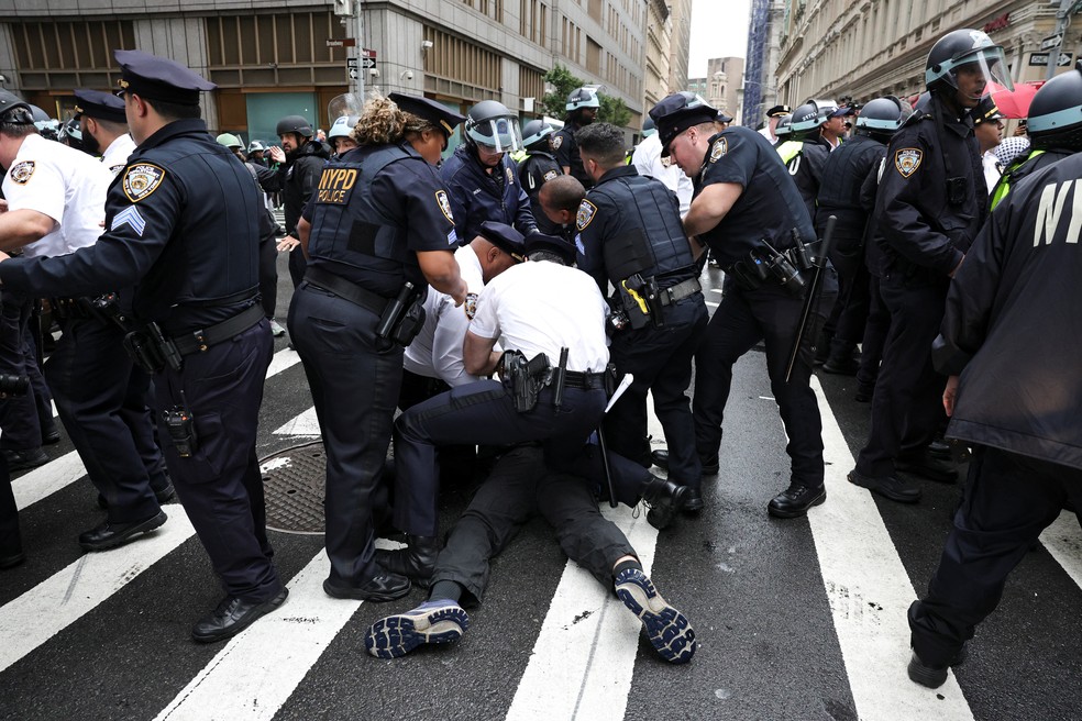 Manifestante é detido em Nova York durante protesto contra Donald Trump no sábado (14) — Foto: Reuters