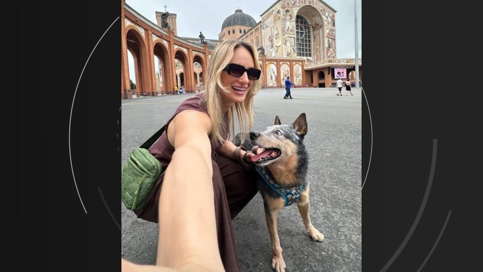 Mariani Gambarini Vassoler, de 31 anos, ao lado do cachorro Chopp. Eles seguiam para o Espírito Santo e pararam para no Santuário de Nossa Senhora Aparecida  — Foto: Arquivo Pessoal