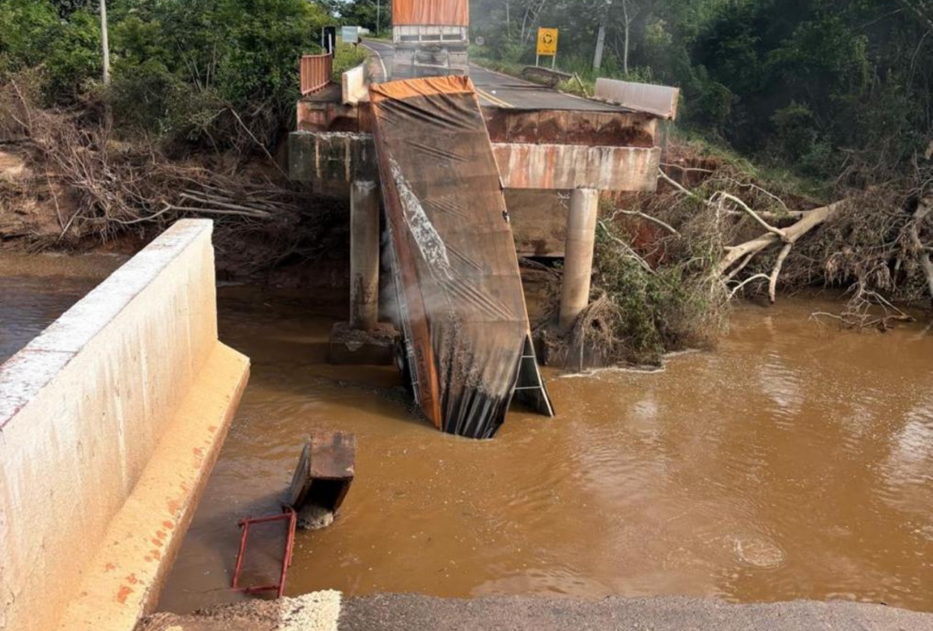 Carreta fica pendurada após ponte ceder com força da chuva em Rio Negro