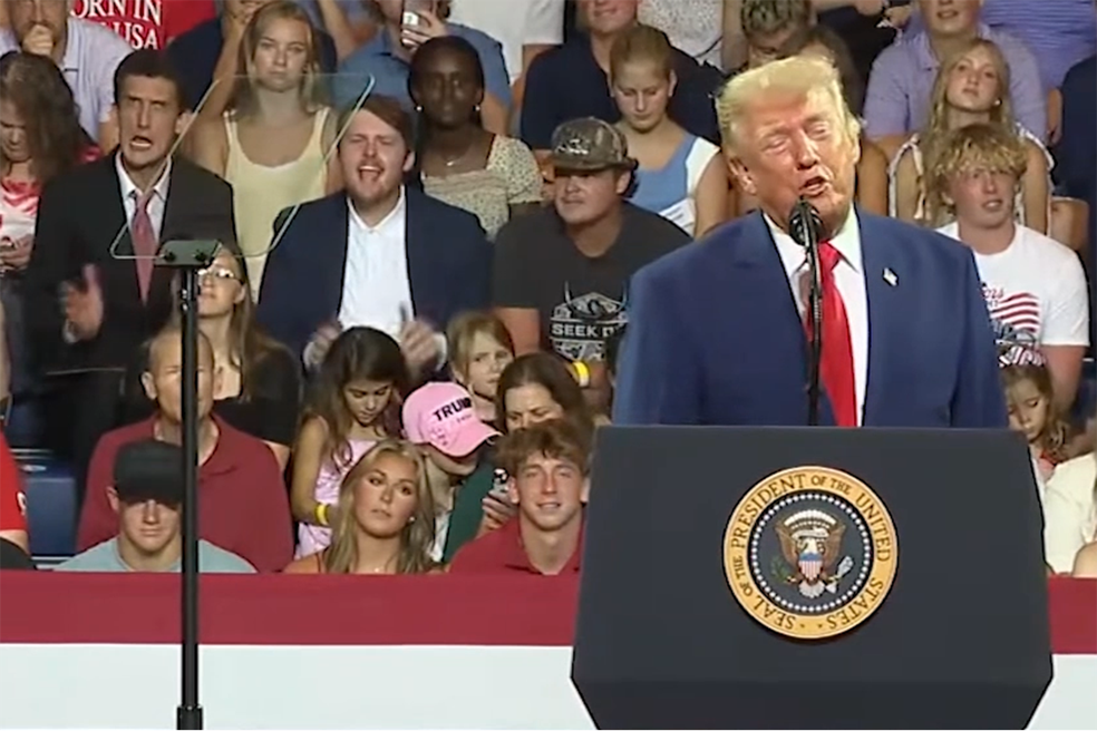 Jovem faz caretas atrás de Trump — Foto: Casa Branca / Divulgação