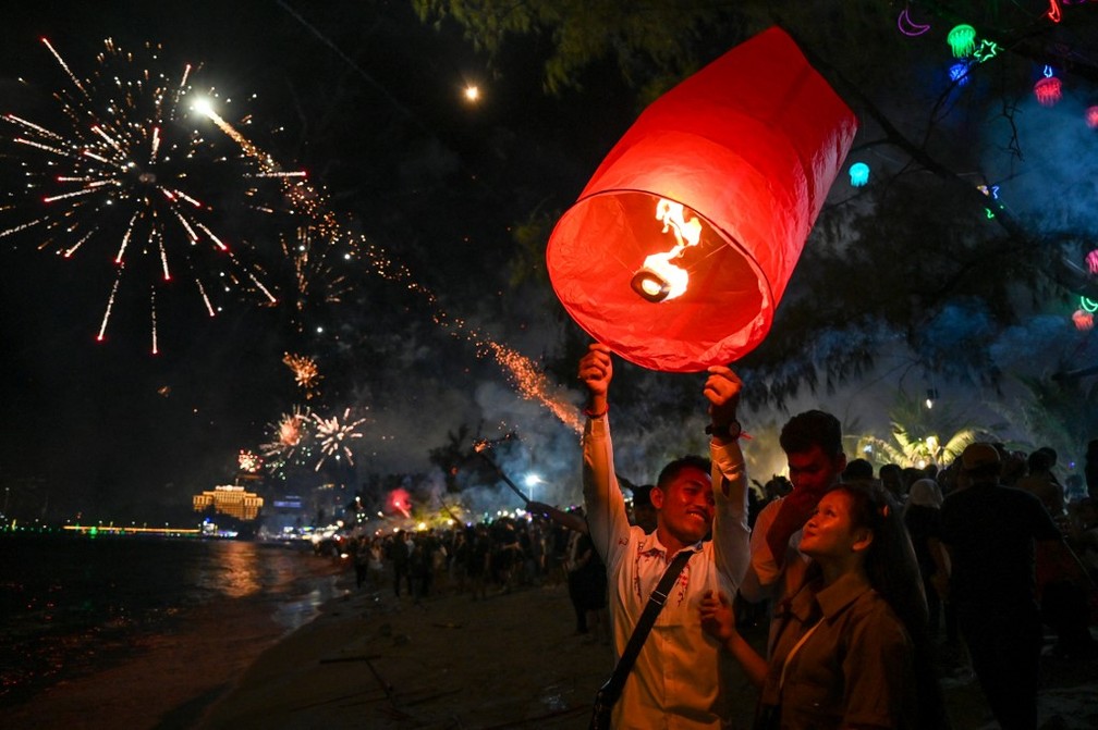 Pessoas comemoram a chegada do ano novo em Sihanoukville, no Cambodja. — Foto: Tang Chhin Sothy/ AFP