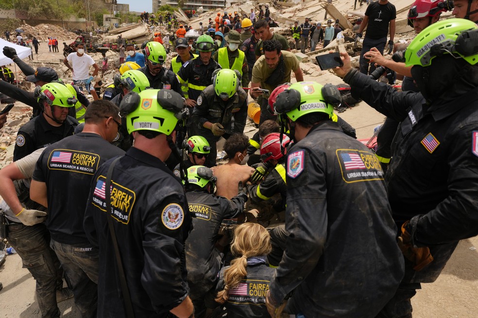 Bombeiros americanos trabalham em resgate em La Guaira, Venezuela, após terremoto — Foto: Matias Delacroix/AP Photo