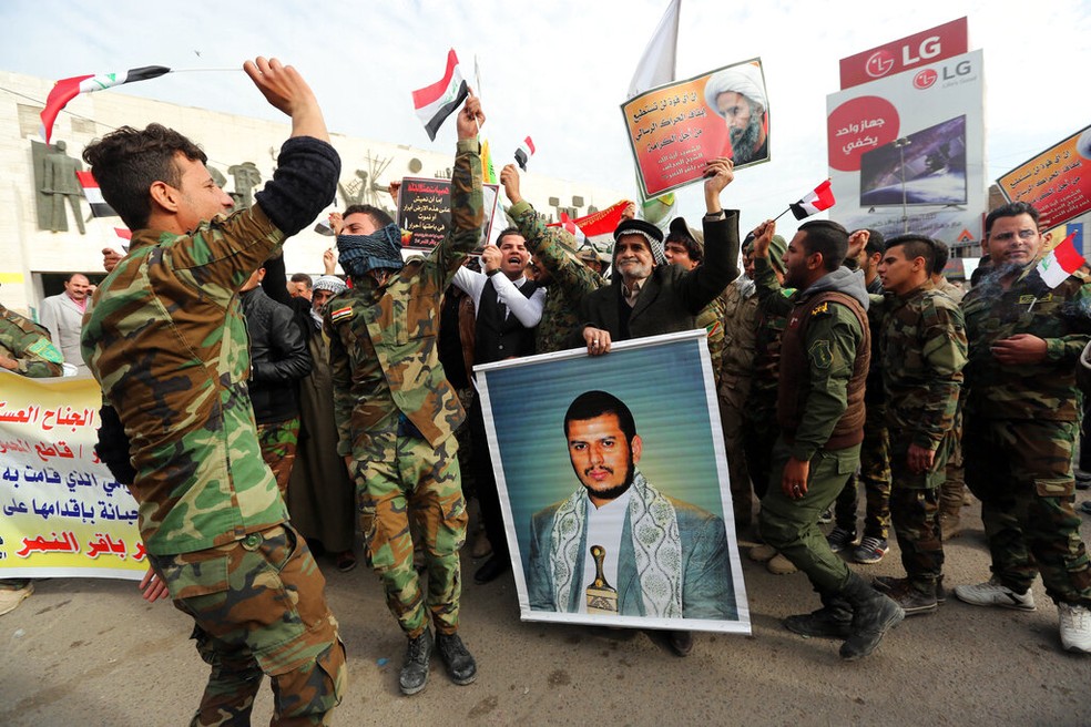 Em imagem de arquivo, integrantes de grupos rebeldes seguram foto do líder dos Houthis, Abdul-Malik al-Houthi, durante protesto na Arábia Saudita, em 2016. — Foto: Khalid Mohammed AP
