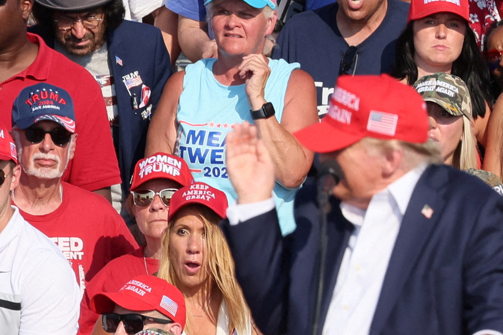 Donald Trump leva mão à orelha assim que começam os sons de tiros em comício — Foto: REUTERS/Brendan McDermid