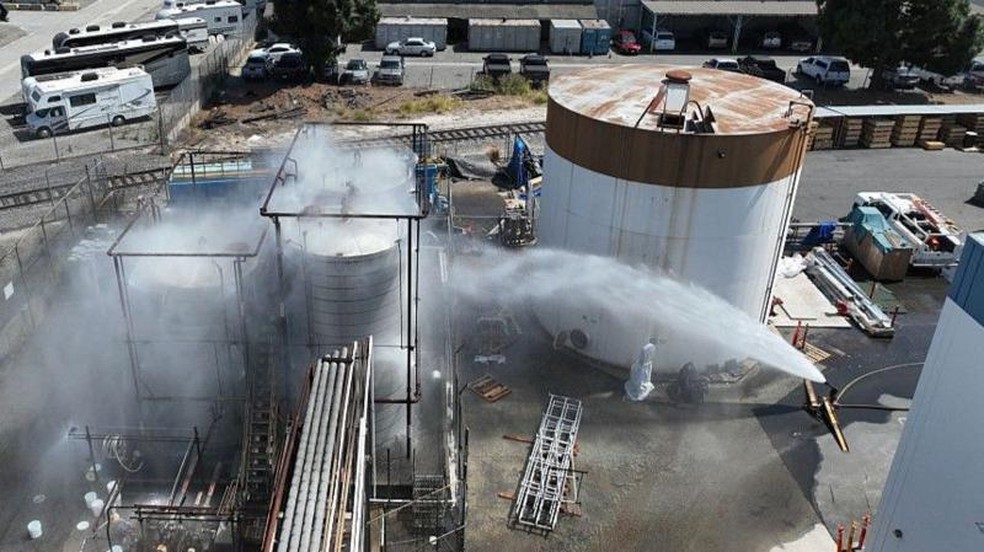 Equipes de bombeiros jogam água em um tanque superaquecido em Los Angeles, em maio. — Foto: Los Angeles Times via Getty Images