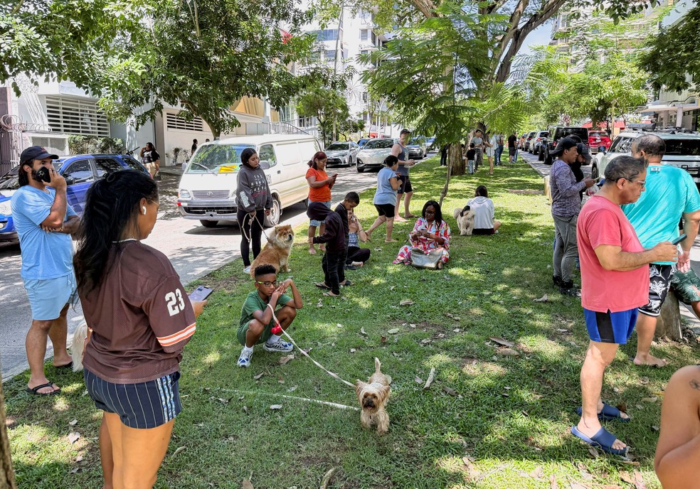 Pessoas com seus animais de estimação estão em uma rua após um terremoto atingir a costa sul do Panamá, na Cidade do Panamá, Panamá, em 9 de outubro de 2026 — Foto: REUTERS/Enea Lebrun