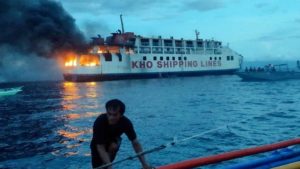 Ao fundo, balsa filipina M/V Esperanza Star em chamas — Foto: Guarda Costeira filipina / via AP