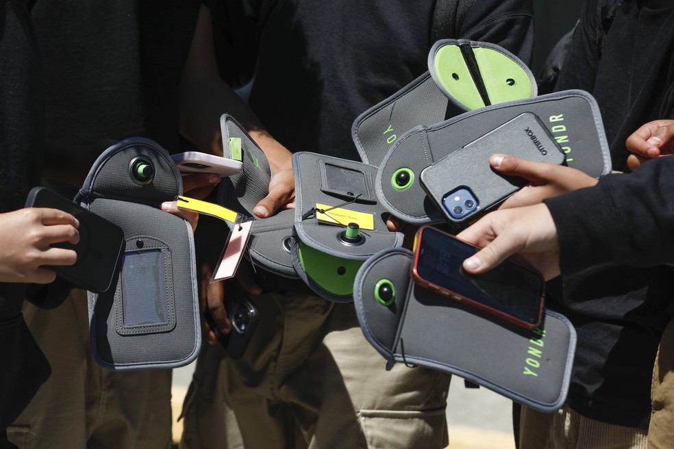 Um aluno usa o celular depois de destravar a bolsa que impede o uso durante o período escolar, na escola Bayside Academy, 16 de agosto de 2024, em San Mateo, Califórnia, EUA. — Foto: Lea Suzuki/San Francisco Chronicle via AP, Arquivo