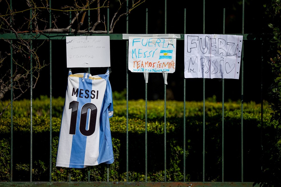 Camisa da seleção argentina com o nome de Lionel Messi é pendurada ao lado de cartazes em frente ao cemitério El Prado, após a morte de Jorge Messi, pai do jogador, em Pérez, em Rosário, Argentina. — Foto: Reuters