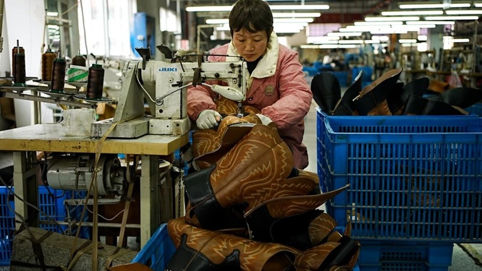 O Sr. Peng diz que a fábrica costumava vender um milhão de pares de botas por ano. — Foto: Xiqing Wang/ BBC