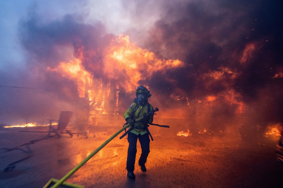 Bombeiro luta contra incêndio durante fortes ventos no oeste de Los Angeles, na Califórnia, em 7 de janeiro de 2025. — Foto: REUTERS/Ringo Chiu TPX IMAGES OF THE DAY
