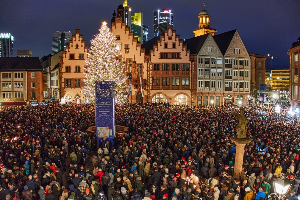 Multidão se reuniu na praça Roememberg, em Frankfurt (Alemanha), aguardando o sino de Natal. — Foto: Michael Probst/AP