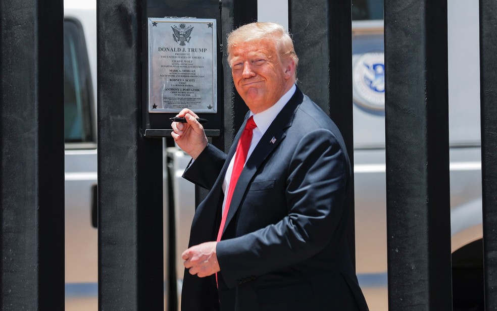O presidente dos EUA, Donald Trump, se prepara para assinar placa em trecho de muro na fronteira com o México, em San Luis, Arizona, na terça-feira (23) — Foto: Reuters/Carlos Barria 