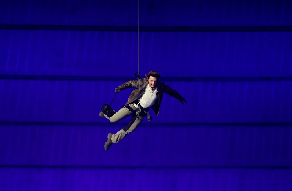 Tom Cruise desce do alto do estádio durante a cerimônia de encerramento das Olimpíadas de Paris 2024 — Foto: Phil Noble/Reuters