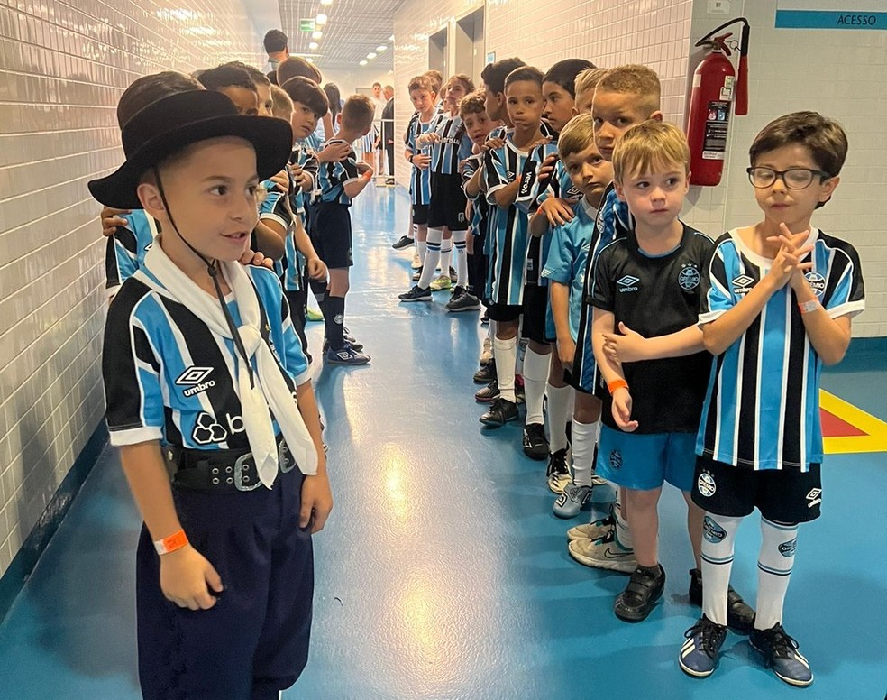 Crianças enfileiradas para entrar no campo da Arena do Grêmio. — Foto: Giovani Grizotti/ RBS TV