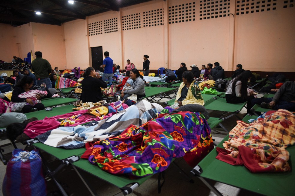 Pessoas dormem e conversam em abrigo aberto pelas autoridades da Guatemala após o vulcão Fuego entrar em erupção, em 4 de agosto de 2026. — Foto: Cristina Chiquin/ Reuters