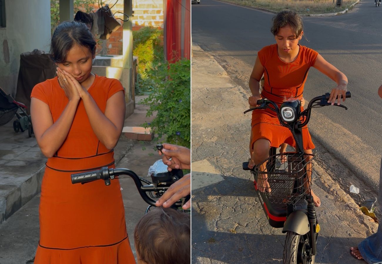 Mãe que levava filho de 2 anos para escola amarrado à cintura ganha bicicleta elétrica no TO; VÍDEO