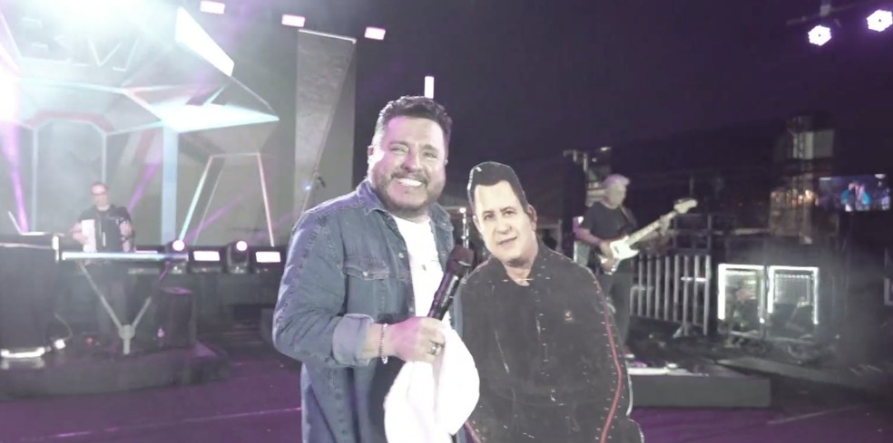 Bruno brinca com display de Marrone, que não pôde estar no show de Mossoró — Foto: Reprodução/Inter TV Costa Branca