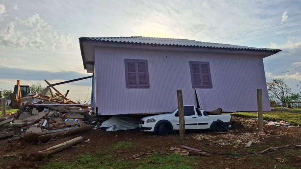 Carro segue sob casa de madeira neste domingo (21) em Barra Bonita — Foto: Defesa Civil/ Divulgação