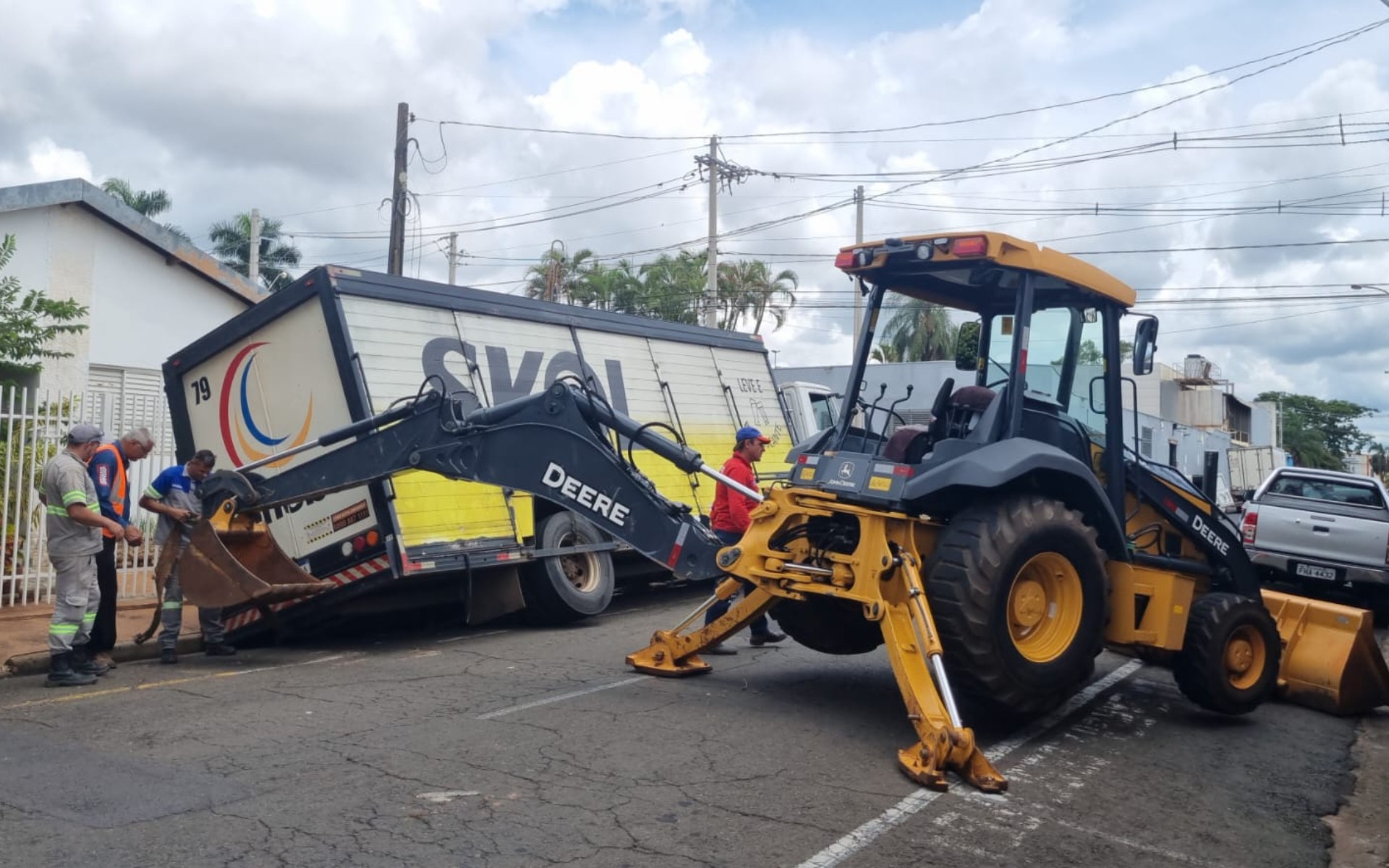 Caminhão fica preso em buraco por quatro horas após asfalto ceder em rua 