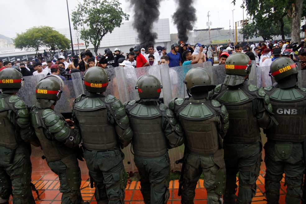 Manifestantes enfrentam foras de segurana enquanto protestam em Puerto La Cruz, Venezuela, aps rgo eleitoral declarar vitria de Maduro — Foto: REUTERS/Samir Aponte