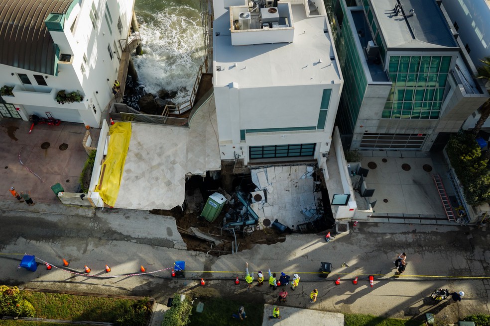 Vista aérea de uma cratera que provocou o desabamento da entrada para carros de uma mansão à beira-mar pertencente ao ator Nicolas Cage, na terça-feira, 8 de setembro de 2026, em Malibu, Califórnia. — Foto: AP Photo/Ethan Swope