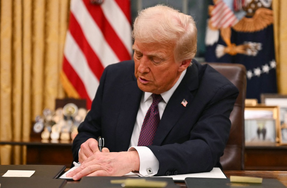 Trump assina ordens executivas, em 20 de janeiro de 2025.   Foto: Jim WATSON / POOL / AFP