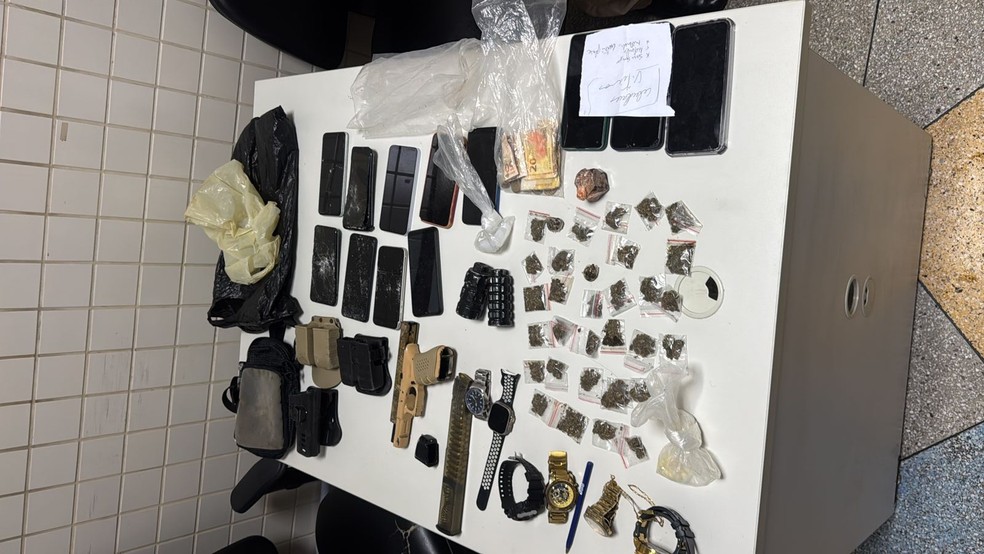 Os policiais apreenderam duas pistolas, um revólver, duas granadas, 12 celulares, seis relógios, maconha, cocaína e dinheiro. — Foto: Arquivo Pessoal